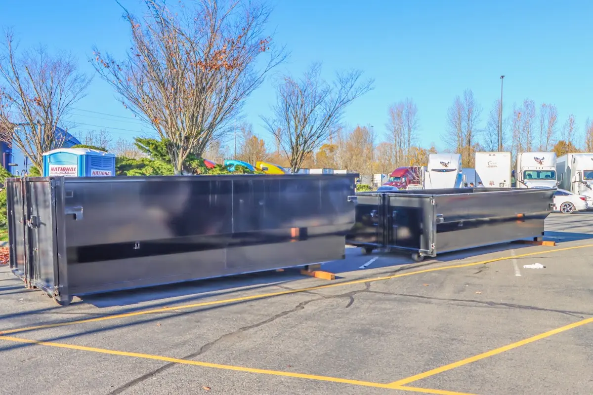 Professional dumpster rental service with roll-off container on residential driveway in Woodinville